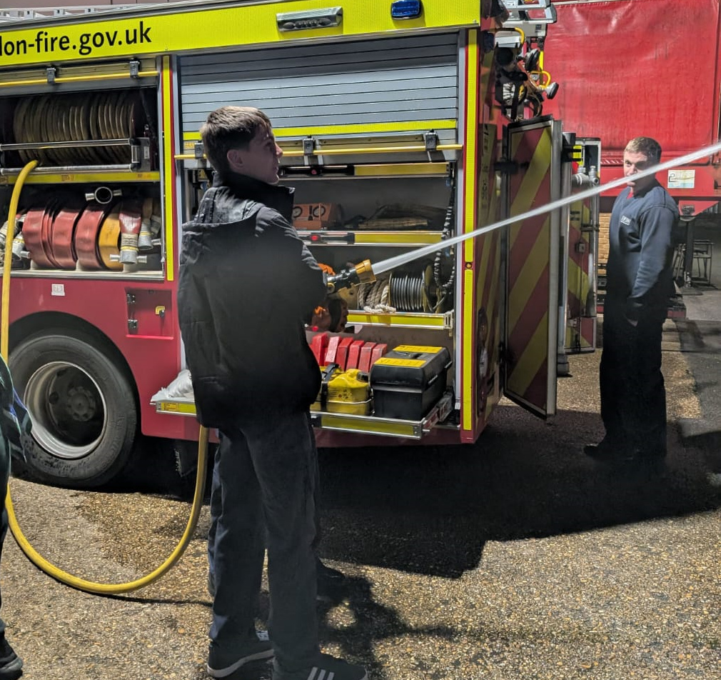Cubs using the fire hoses