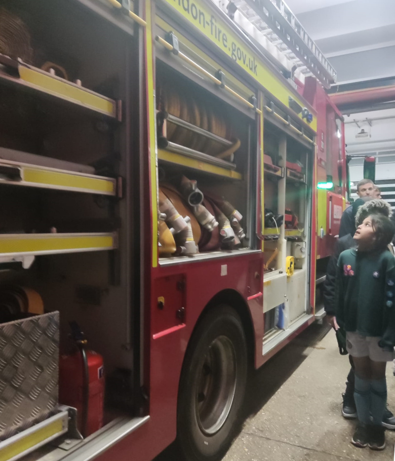 2nd/9th Ruislip Cubs being shown the kit on the fire engine