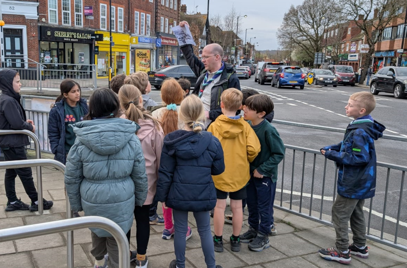 Cubs on Ruislip High Street comparing the buildings to the old photo